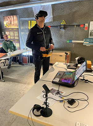 A course participant is using the Spray Concrete VR goggle software to train
